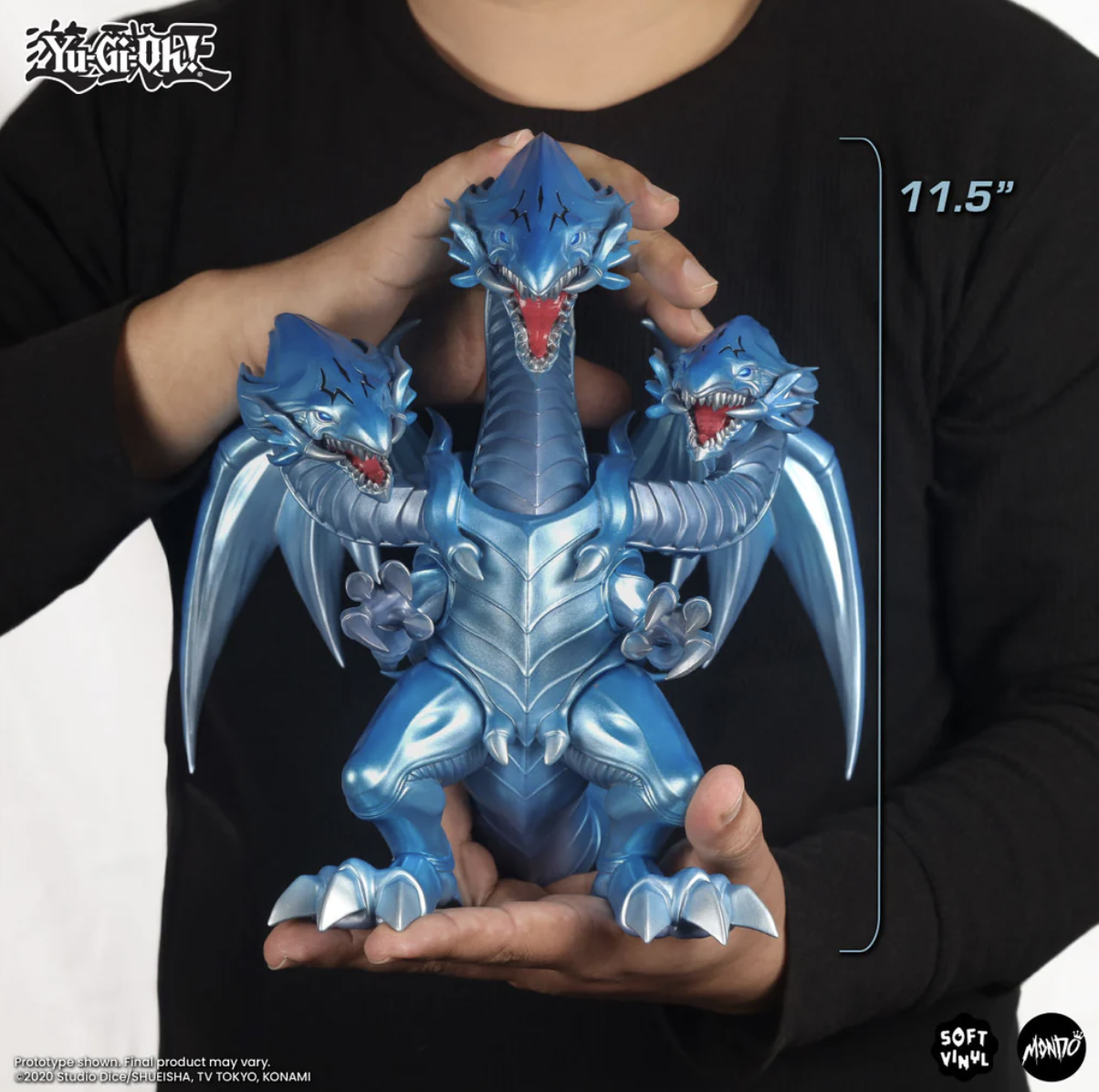 Person holds nearly foot-tall three headed dragon figure